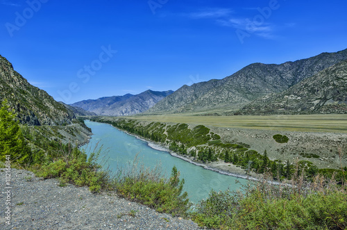 Summer mountain landscape with turquoise river and colorful rocks