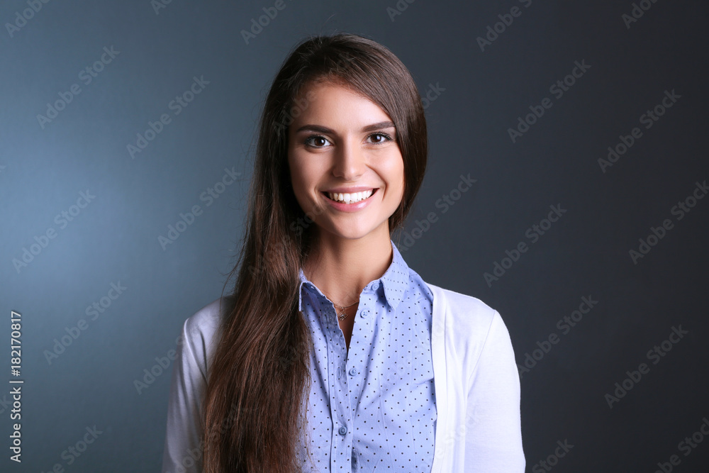 Portrait of a businesswoman , against dark background. Woman smiling. Portrait of a woman Portrait of a businesswoman , against dark background. Woman smiling. Portrait of a woman