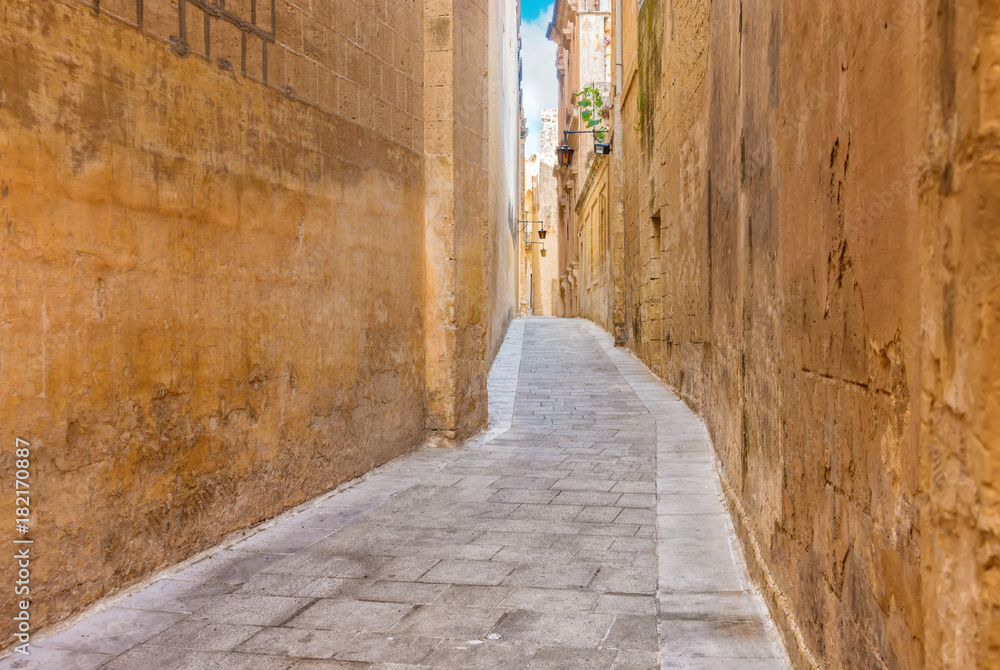 beautiful view of narrow medieval street in old town Mdina, Malta, toned style