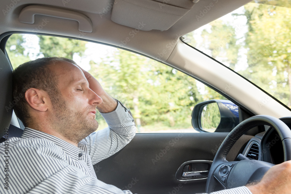 Stressed and annoyed male driver on the road during the rush hour Stressed and annoyed male driver on the road during the rush hour