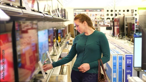 Woman buying TV in a store.