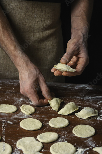 The chef prepares vegetarian ravioli with cabbage. Style rustic.