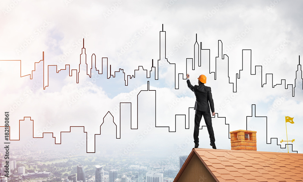 Man architect draw silhouette of modern city on blue sky. Mixed media Man architect draw silhouette of modern city on blue sky. Mixed media