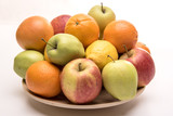 Tasty fruit orange, apples and lemon on the wooden plate