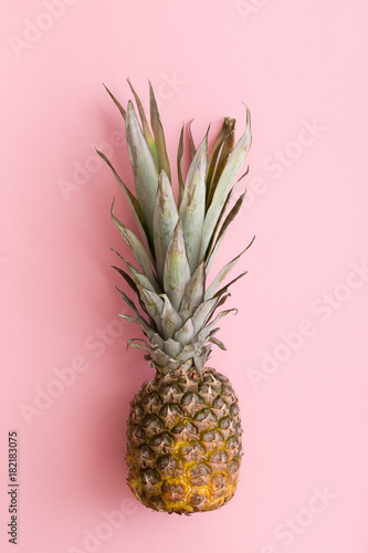 Top view on pineapple on light pink background.