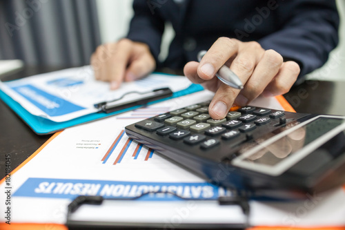 Man using calculator and writing make note with calculate