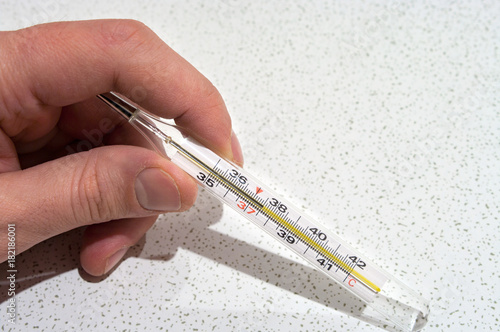 Mercury thermometer which showing 37.5C