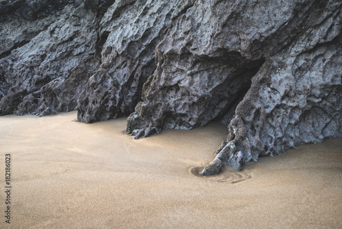 Intimate landscape image of rocks and sand on Broadhaven beach in Pembrokeshire Wales photo