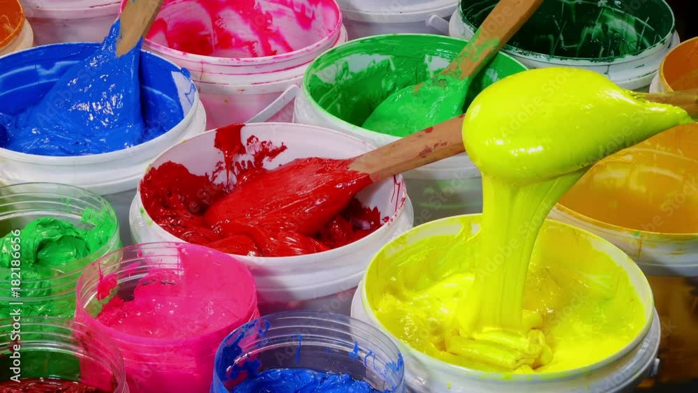 Colored wooden spoon used for scoop paint buckets. wooden spoon scoop