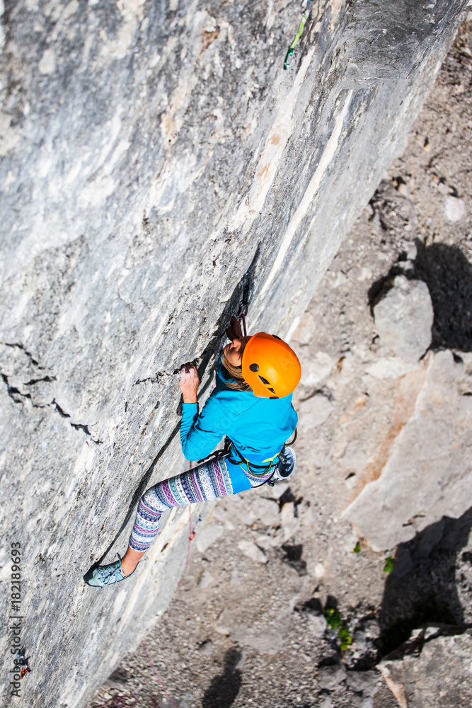 The girl climbs the rock.