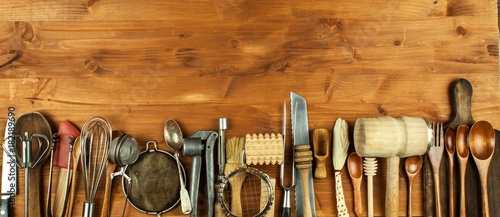 Old kitchen utensils on a wooden board. Sale of kitchen equipment. Chef's tools.
