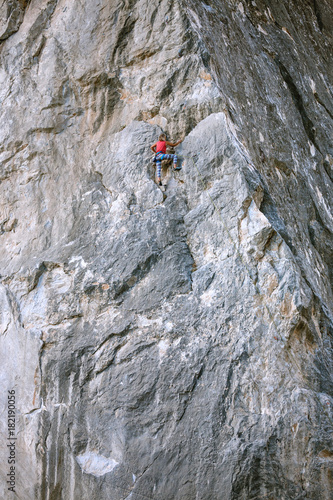 The girl climbs the rock.