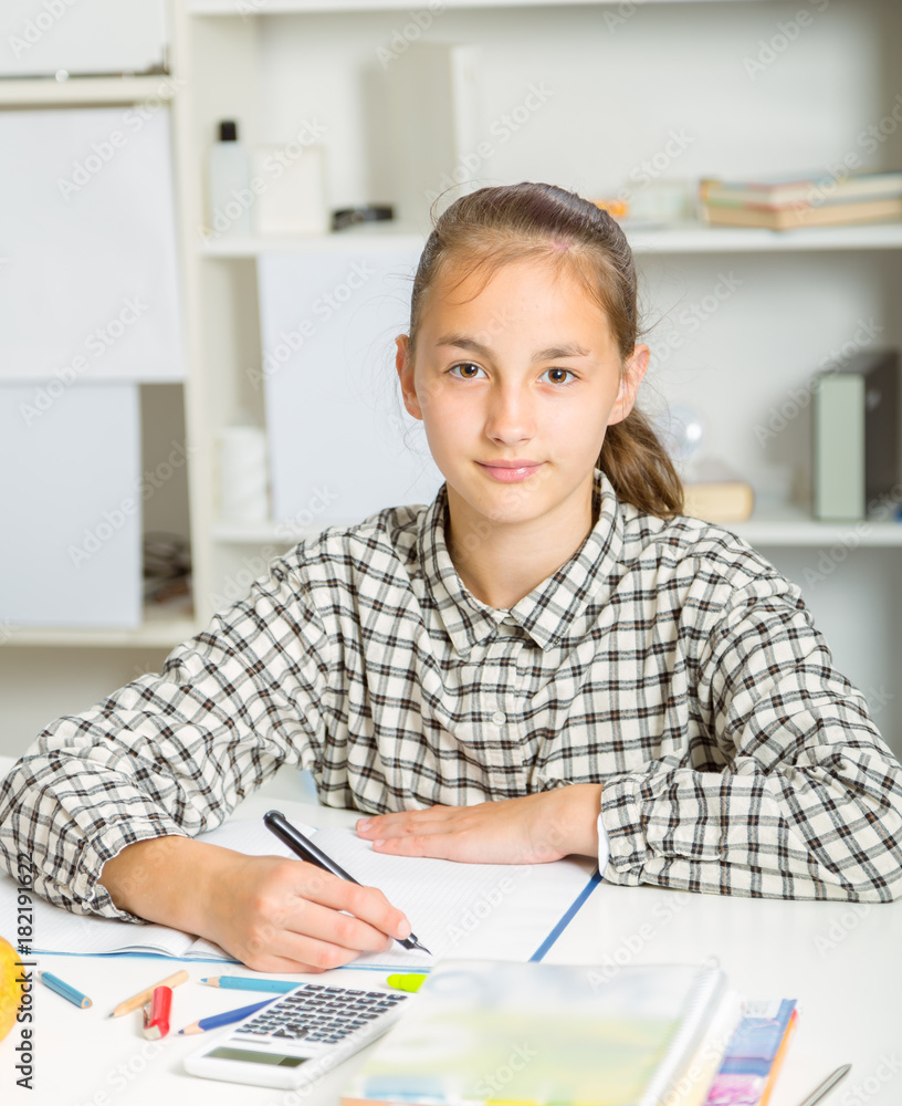 Teenage girl preparing for exams. Teenage girl doing homework. Teenage girl preparing for exams. Teenage girl doing homework.