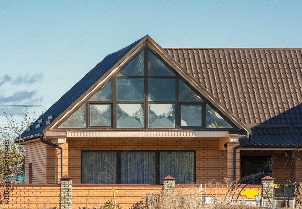 Attic panoramic window under the roof reflects clouds sky Attic panoramic window under the roof reflects clouds sky