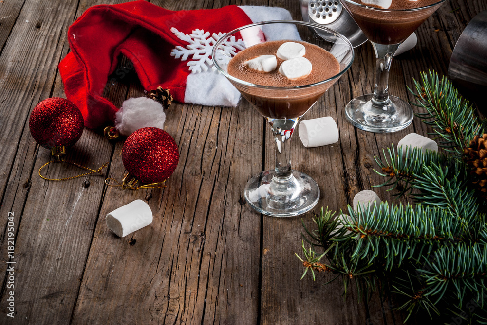 Ideas for Christmas party drinks, homemade Hot Chocolate Martini cocktails with marshmallow, on old rustic wooden table with christmas decorations, copy space