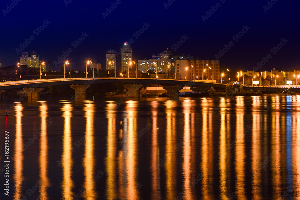 Havana bridge in Kiev at night with colorful illumination and reflection in Dnieper river