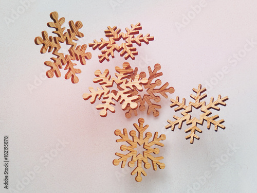 Christmass winter card with wooden snowflakes falling background