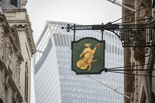 Vintage London street sign against the backdrop of City buildings photo