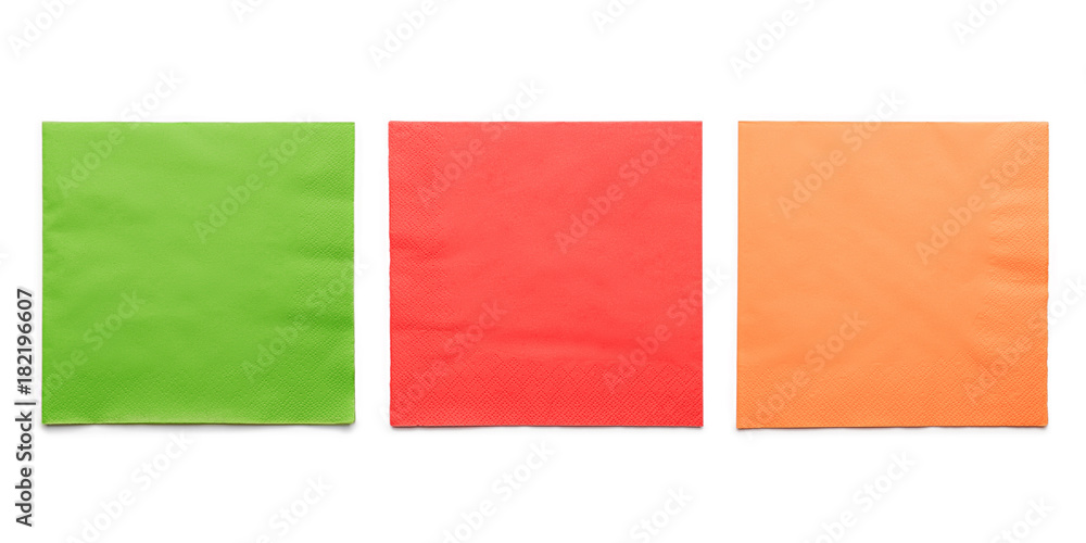 Three colored paper napkins on white