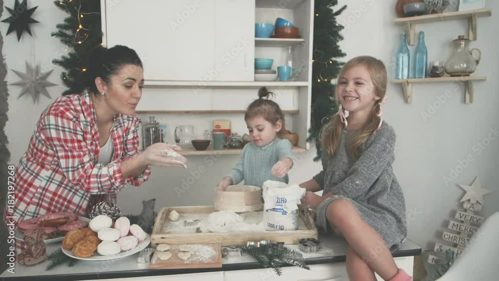 happy family in the kitchen. mother and children preparing the dough, bake cookies happy family in the kitchen. mother and children preparing the dough, bake cookies