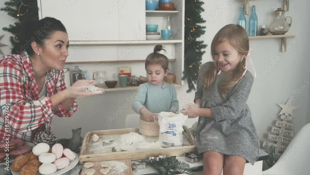 happy family in the kitchen. mother and children preparing the dough, bake cookies happy family in the kitchen. mother and children preparing the dough, bake cookies