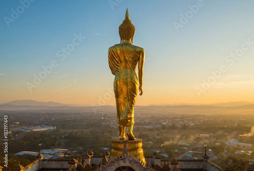 The iconic standing Buddha on Wat Phra That Khao Noi one of the most tourist attraction places in Nan province of northern Thailand during the sunrise.