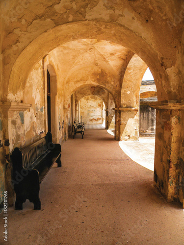 Old Historic Hallway with Benches and Arches at Castillo San Juan © Christine