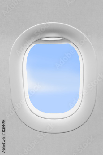 Airplane window and blue sky