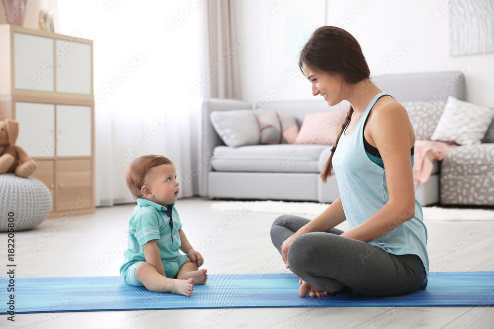 Young mother doing yoga with baby at home Young mother doing yoga with baby at home