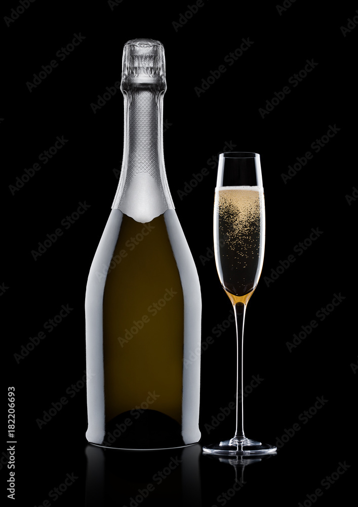 Bottle and glass of yellow champagne on black Bottle and glass of yellow champagne on black