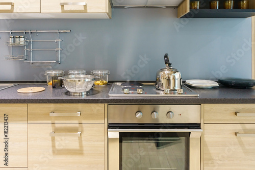 Modern kitchen furniture with contemporary kitchenware like hood, induction and oven