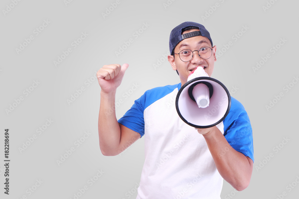 Young Man Shouting with Megaphone, Promotion Concept Young Man Shouting with Megaphone, Promotion Concept
