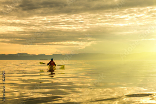 A man in a sea kayak on Lake Baikal © greenlex