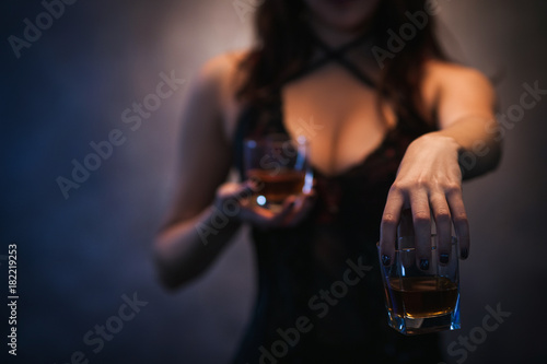 Bad influence. Woman offering alcohol and seducing. Amoral and indecent lifestyle concept photo