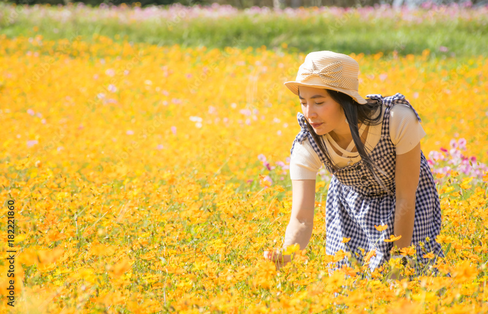 Woman asia walking in the flower field cosmos and sunshine
