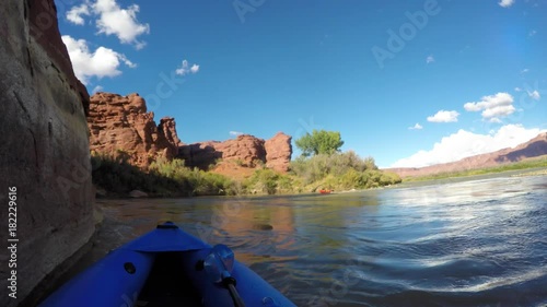 A family in kayaks on the colorado river near Moab Utah Desert