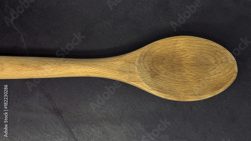 Wooden spoon on black slate