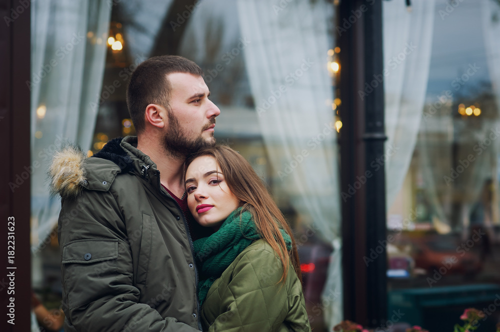 Young loving couple on a city street . Romantic couple in autumn city walk