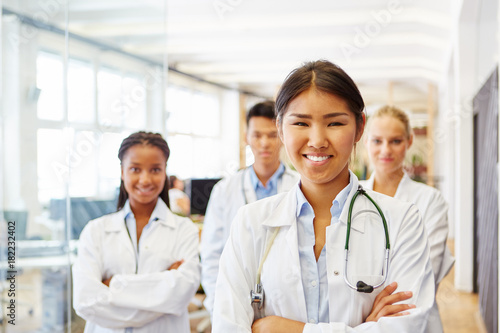 Junge asiatische Ärztin vor ihrem Team