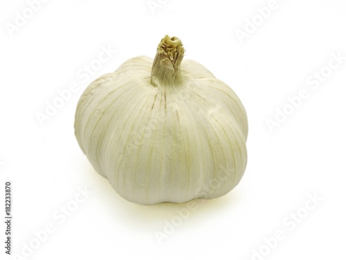 Garlic head isolated on white background. A type of cooking ingredient. Herbal plants and healthy food related to blood pressure, antibiotics, etc. Side view, Copy space on the left and right. 