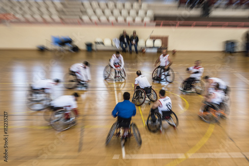 Unidentified disabled people doing exercise before playing game of wheelchair basketball at a basketball Show.TURKEY, ISTANBUL,21 JANUARY 2017