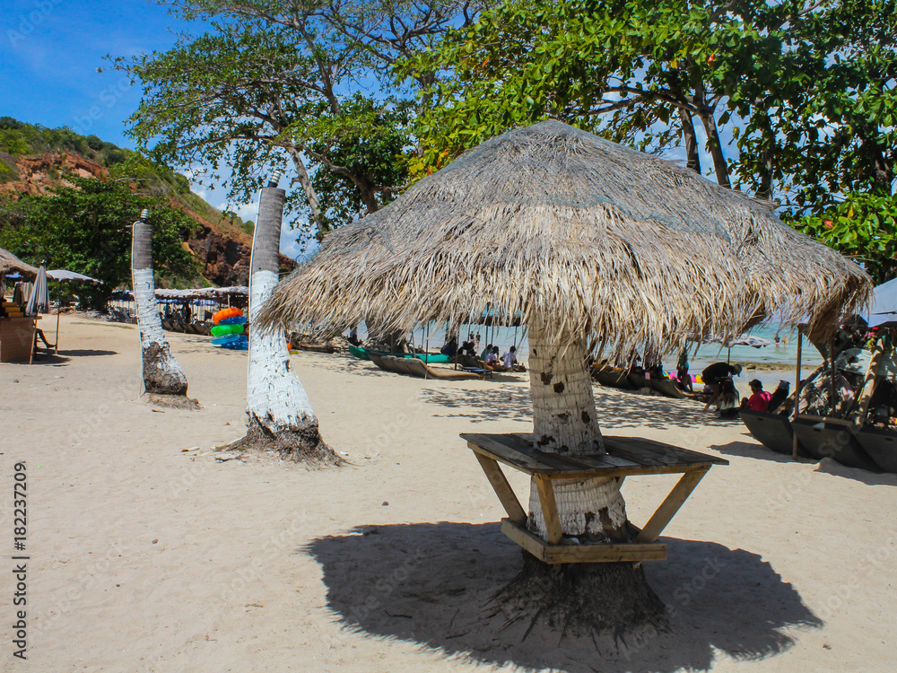 Fototapeta premium Natural straw umbrella on beautiful beach
