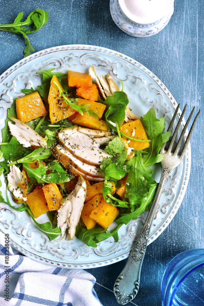 Pumpkin salad with chicken and arugula.Top view. Pumpkin salad with chicken and arugula.Top view.