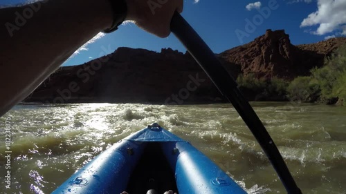 A father and boys in kayaks on the colorado river near Moab Utah Desert