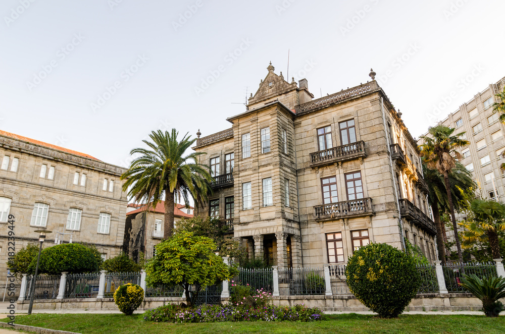 Historical masonry building in Vincenti gardens in Pontevedra (Spain). Palms and plants in the entrance
