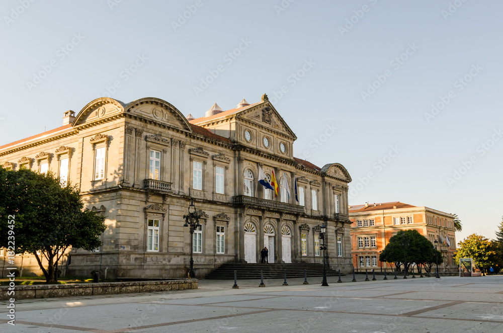 Facade of Deputacion Provincial of Pontevedra (Spain) with flags