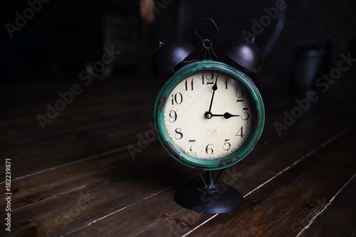 Retro clock. On an old wooden floor.