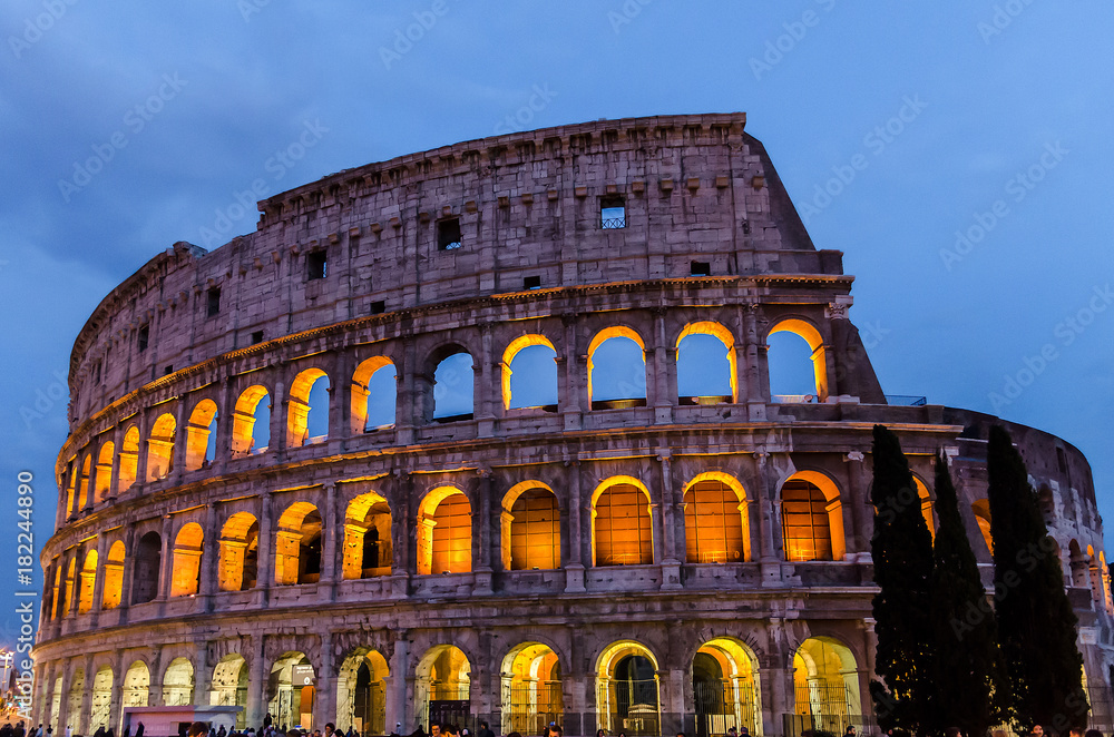 View of Coliseum illuminated at night, Rome, Italy.