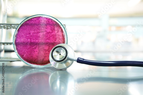 stethoscope with purple petri dish in medical science labortory background photo