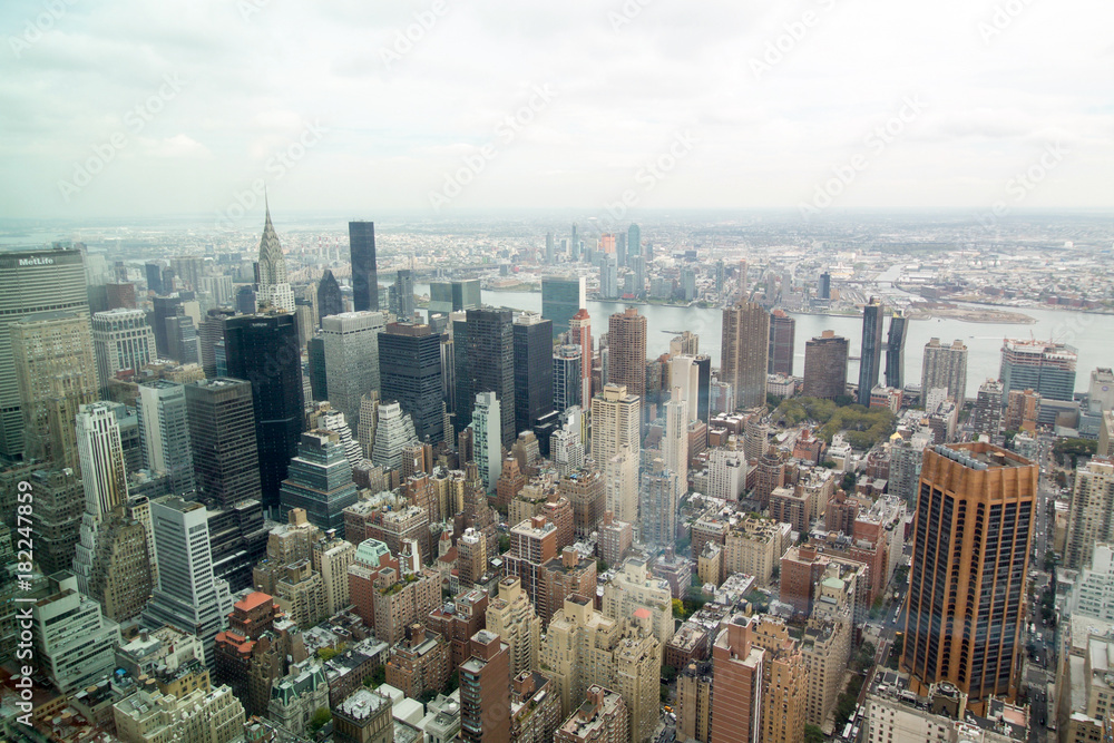 aerial view of a part of manhattan in New York city with  skyscrapers in a cloudy day
